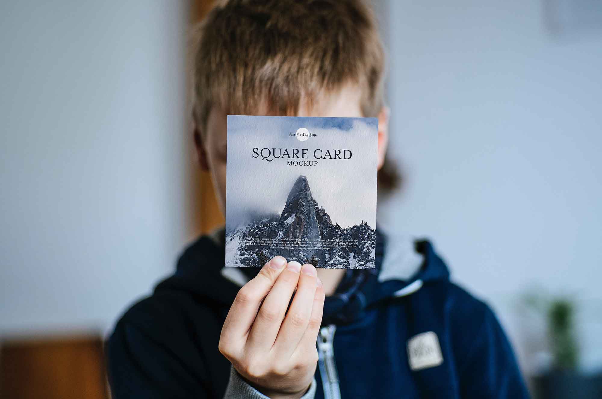 Boy Showing Square Card Mockup (PSD)