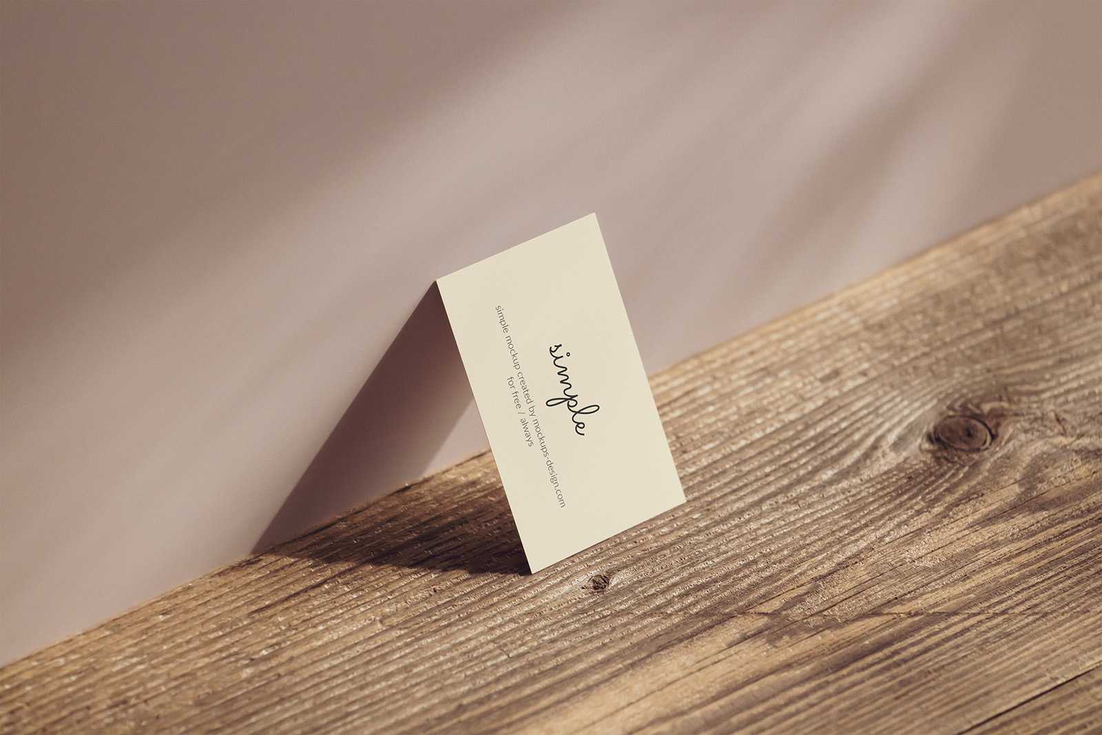 Business card lying on the wall mockup