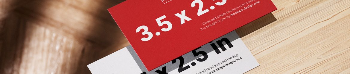 Business cards lying on a wooden table mockup