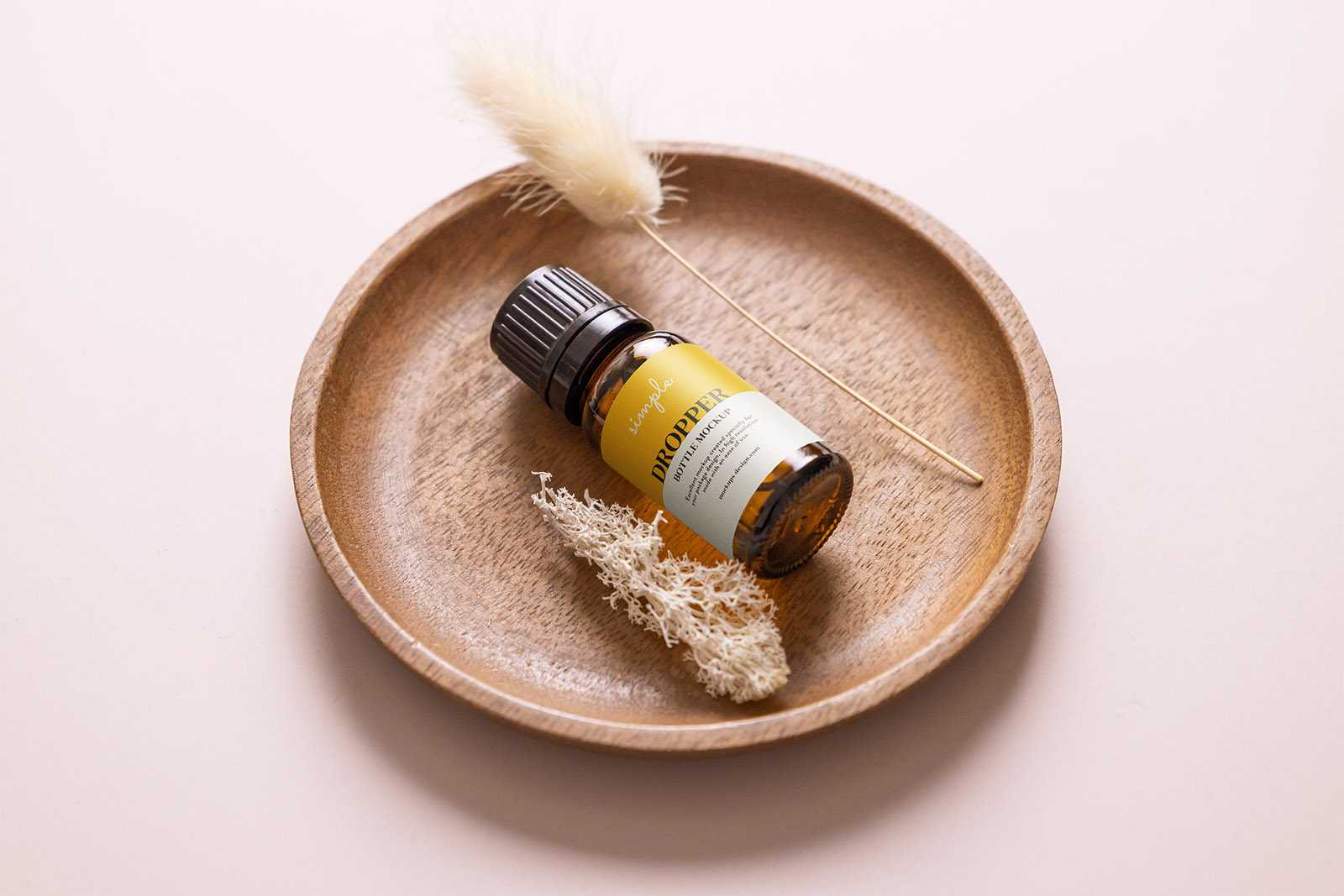 Essential oil bottle in the bowl mockup