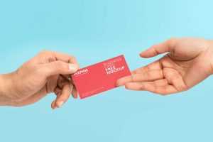 Free Business Card Given in Hand Mockup (PSD)