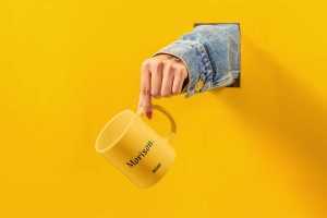 Free Cup with Hand Mockup (PSD)
