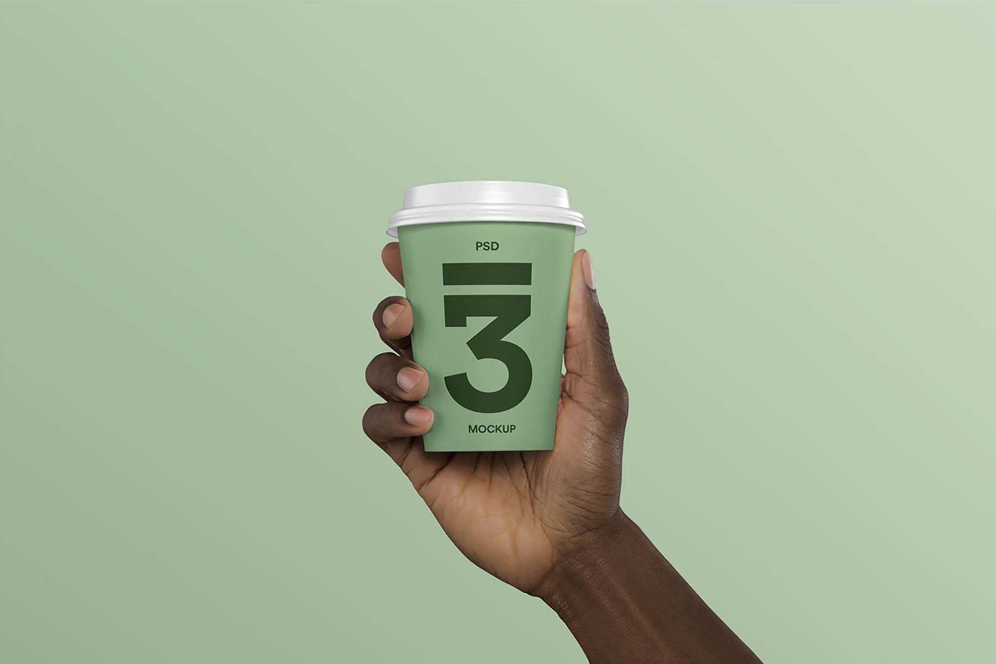 Free Hand Holding Coffee Cup Mockup (PSD)