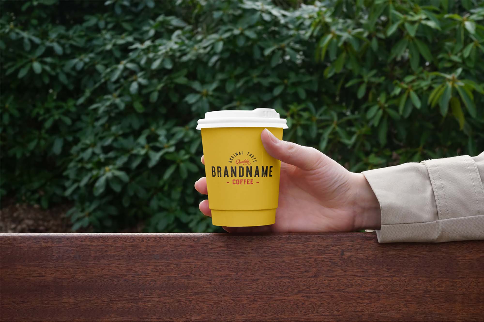 Free Hand Holding Coffee Cup Mockup (PSD)