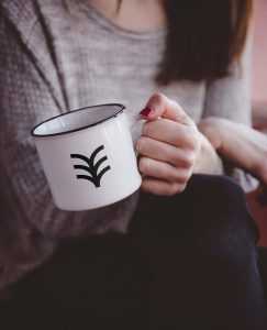 Free Hand Holding Metal Mug Mockup (PSD)