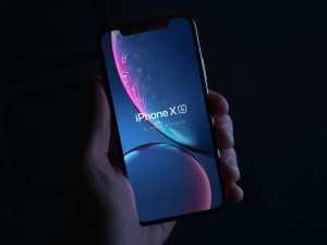 Free iPhone XS in Hand Mockup (PSD)