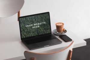 Free MacBook on Table Mockup (PSD)