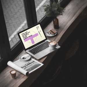 Free MacBook Pro in Cafe Mockup (PSD)