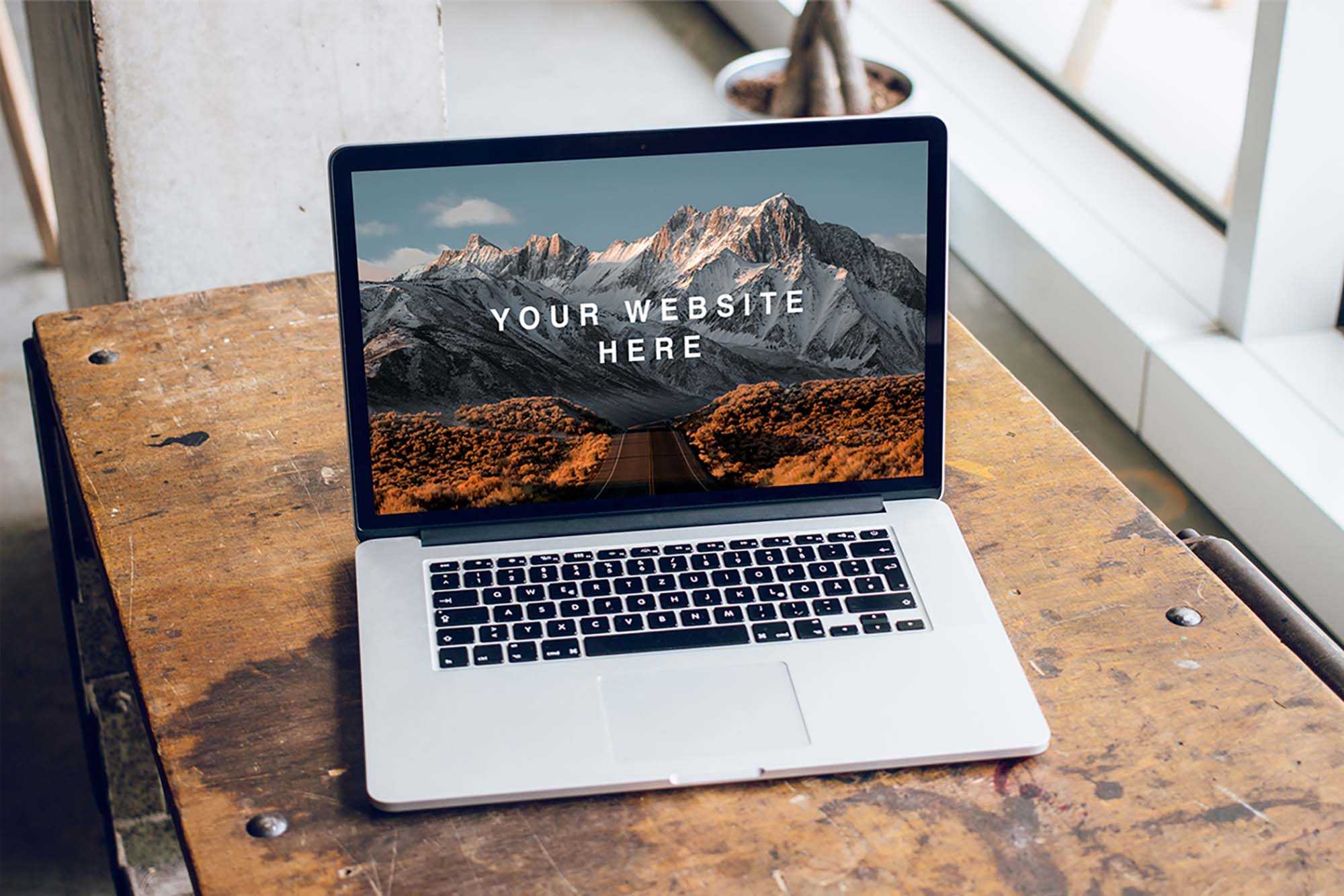 Free MacBook Pro on Table Mockup (PSD)