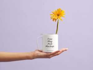 Free Mug in Hand Mockup (PSD)