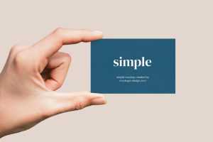 Hand holding business card mockup