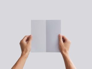 Man Holding Bifold Brochure Mockup (PSD)