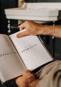 Opened Book in Hand Mockup